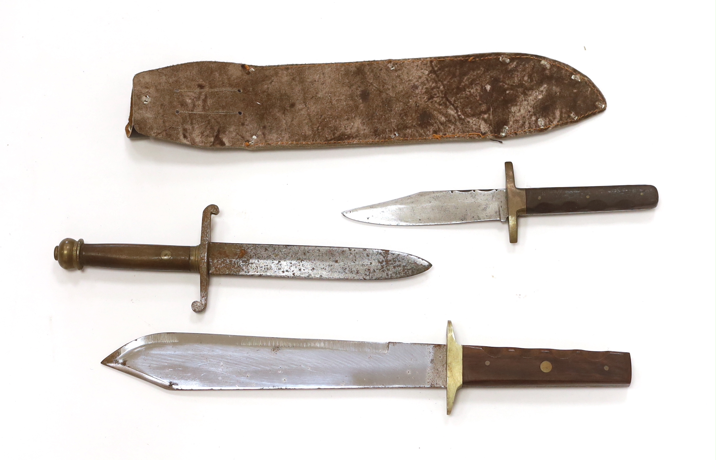 A Bowie knife with wooden grip, in a leather sleeve, blade etched with ‘Siege of The Alamo 1836 Col. Jim Bowie’s final stand’, blade 26.5cm, together with two smaller knife daggers (3)